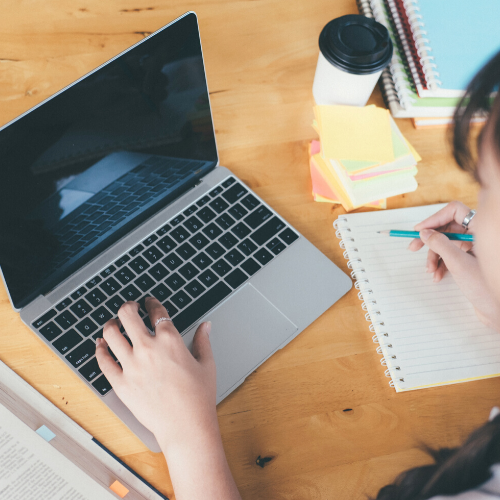 woman with laptop and notebook