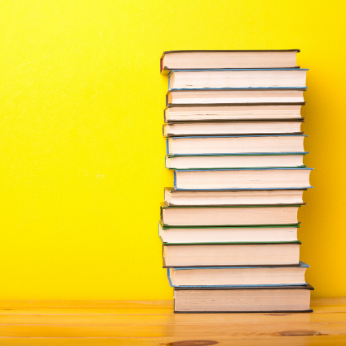 stack of books, yellow background