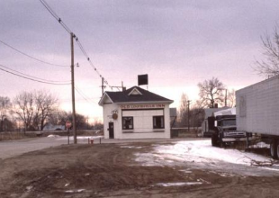 Old Louisville Inn in the 1970s-80s. A white building next to train tracks.
