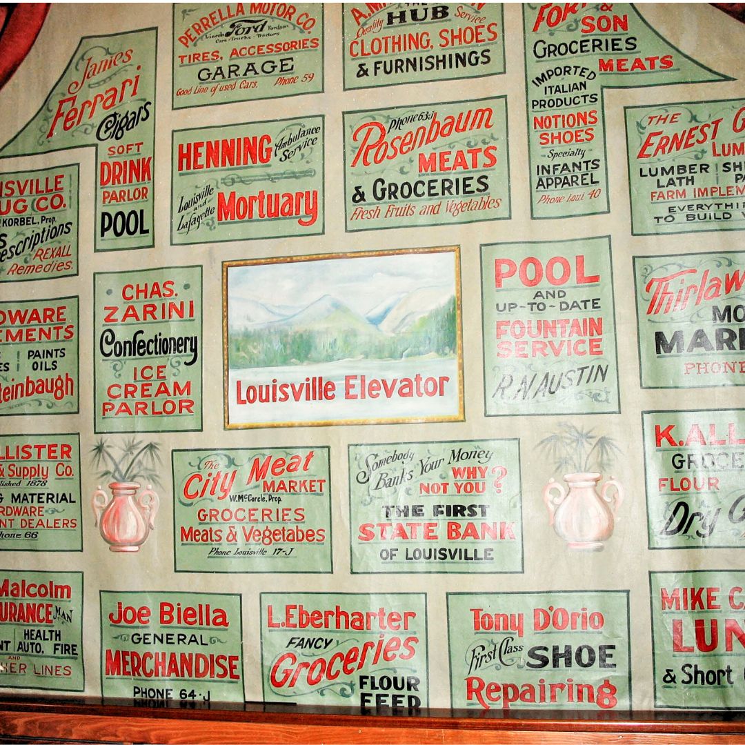 A theatre curtain from 1927 Louisville with names of Louisville businesses printed on it